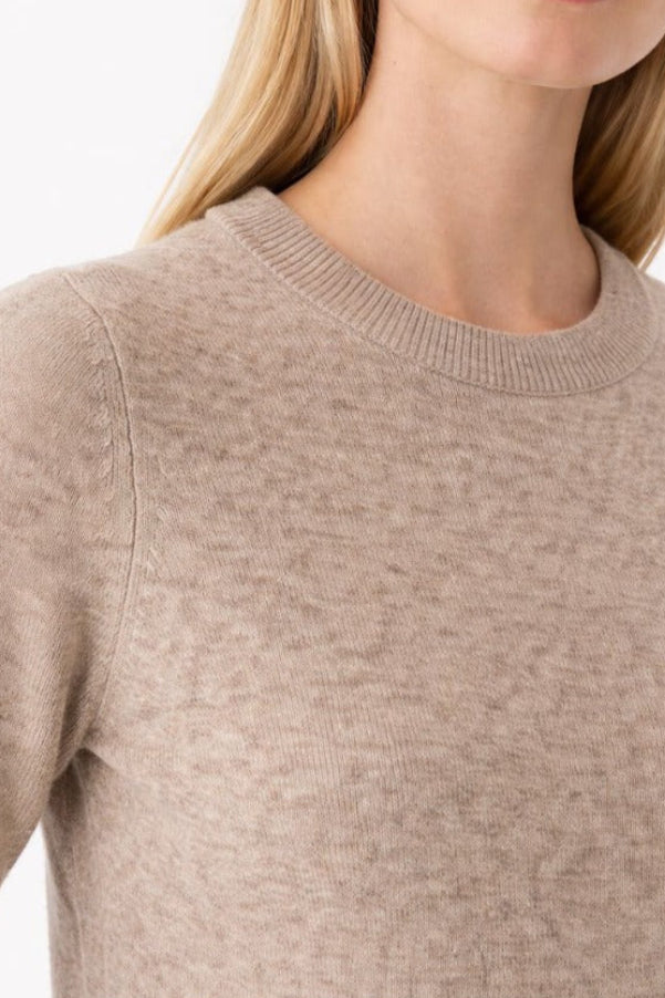 Close up of Amara cashmere crewneck sweater in beige, showing soft knit texture
