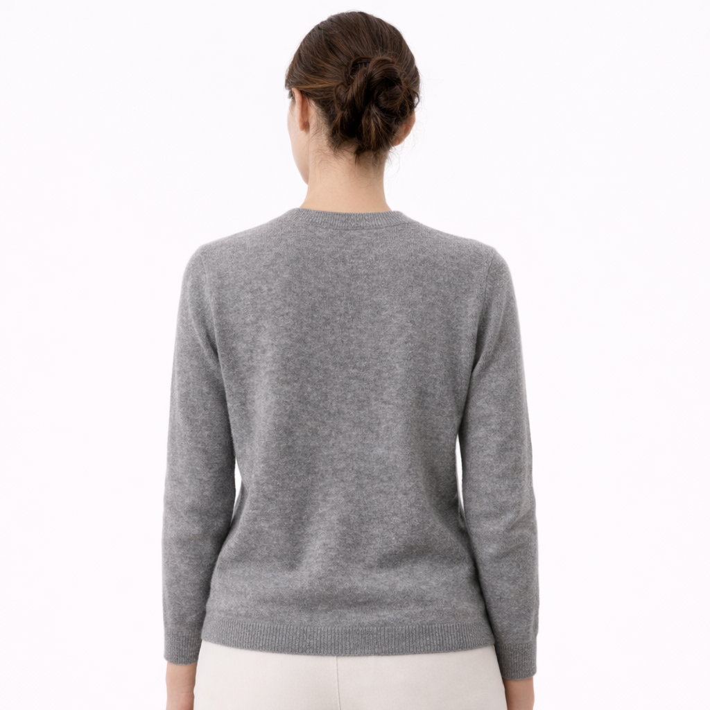 Model wearing Eva V-Neck Cashmere Sweater showing the back of the sweater